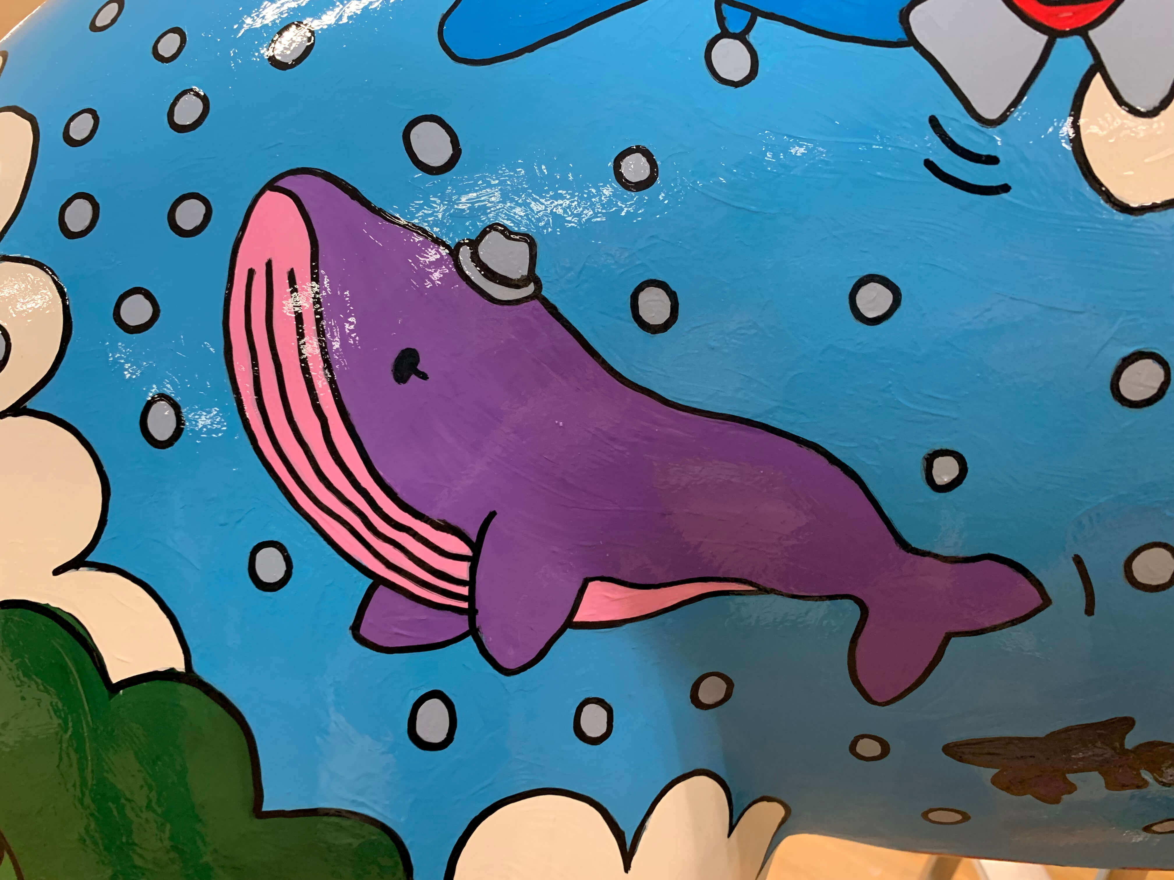 an illustration of a whale flying through the sky